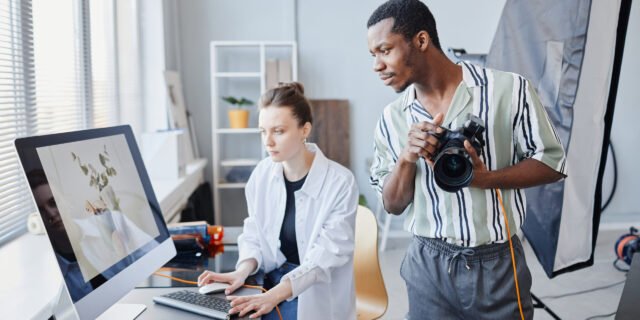 Minimal portrait of two photographers working as team on product photoshoot in studio
